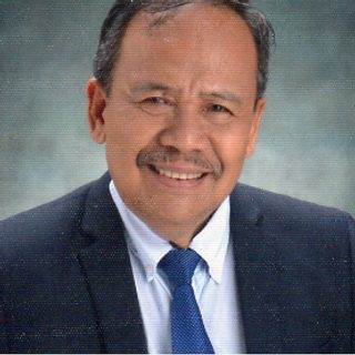 Rev. Joshue Zuriel G. Tiempo, Ph.D., President, in a suit and tie