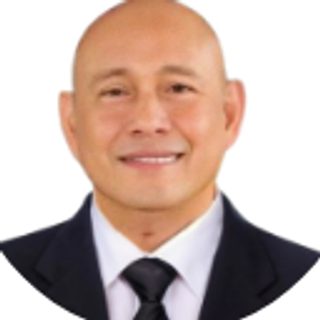 Hon. Carmelo O. Villacete, Member Alumni Representative, in a suit and tie